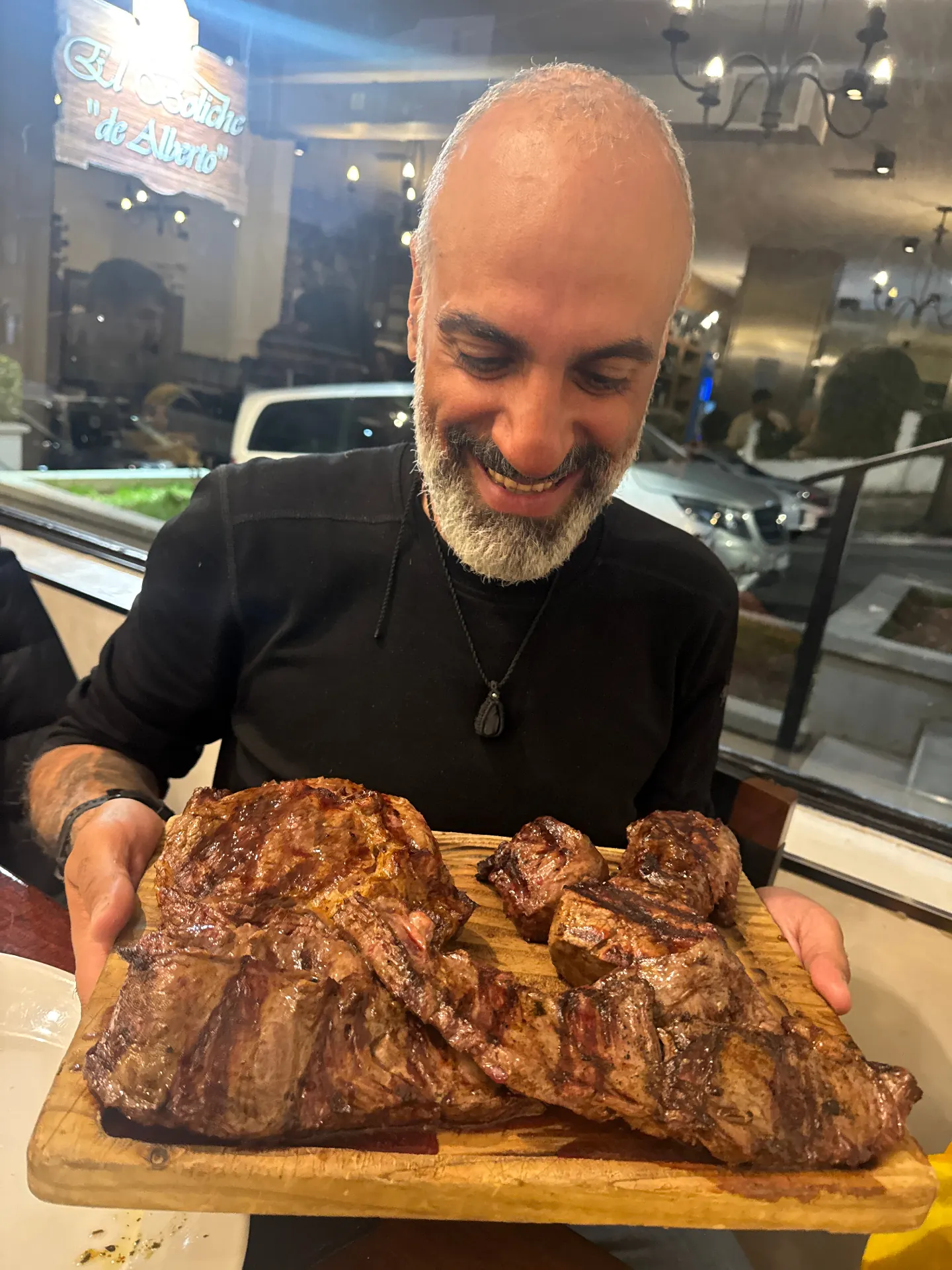Argentinian asado parrilla with grilled beef ribs and chorizo at a local steakhouse