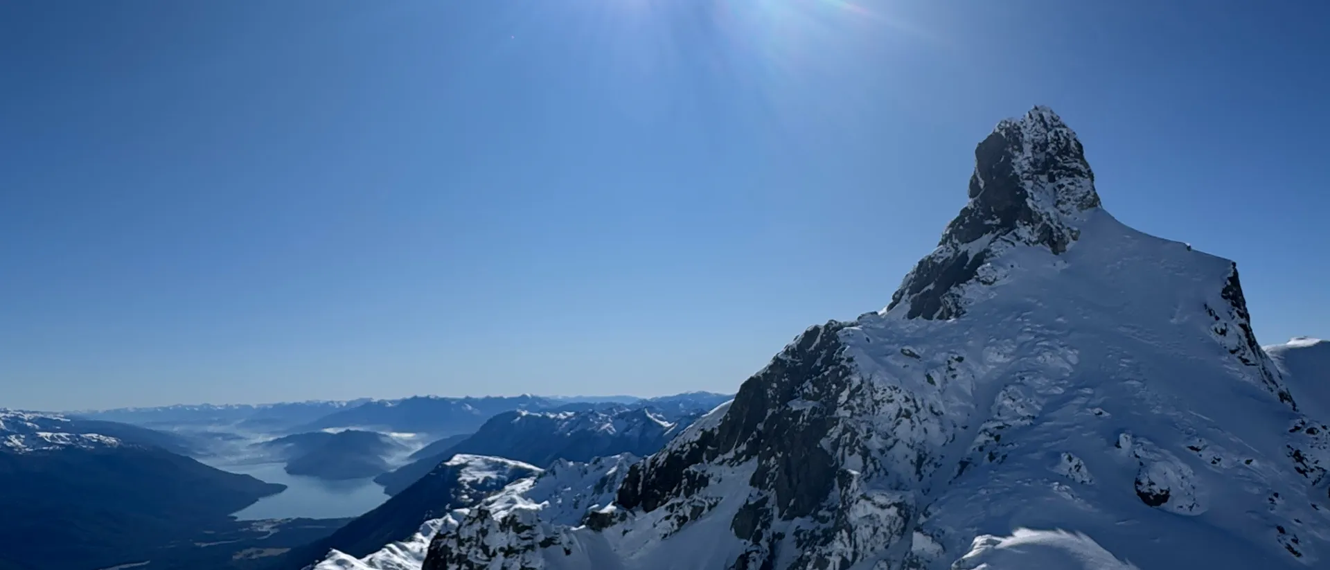 Snow-covered Andes peak under a clear blue sky, backdrop for South America ski trip add-on services