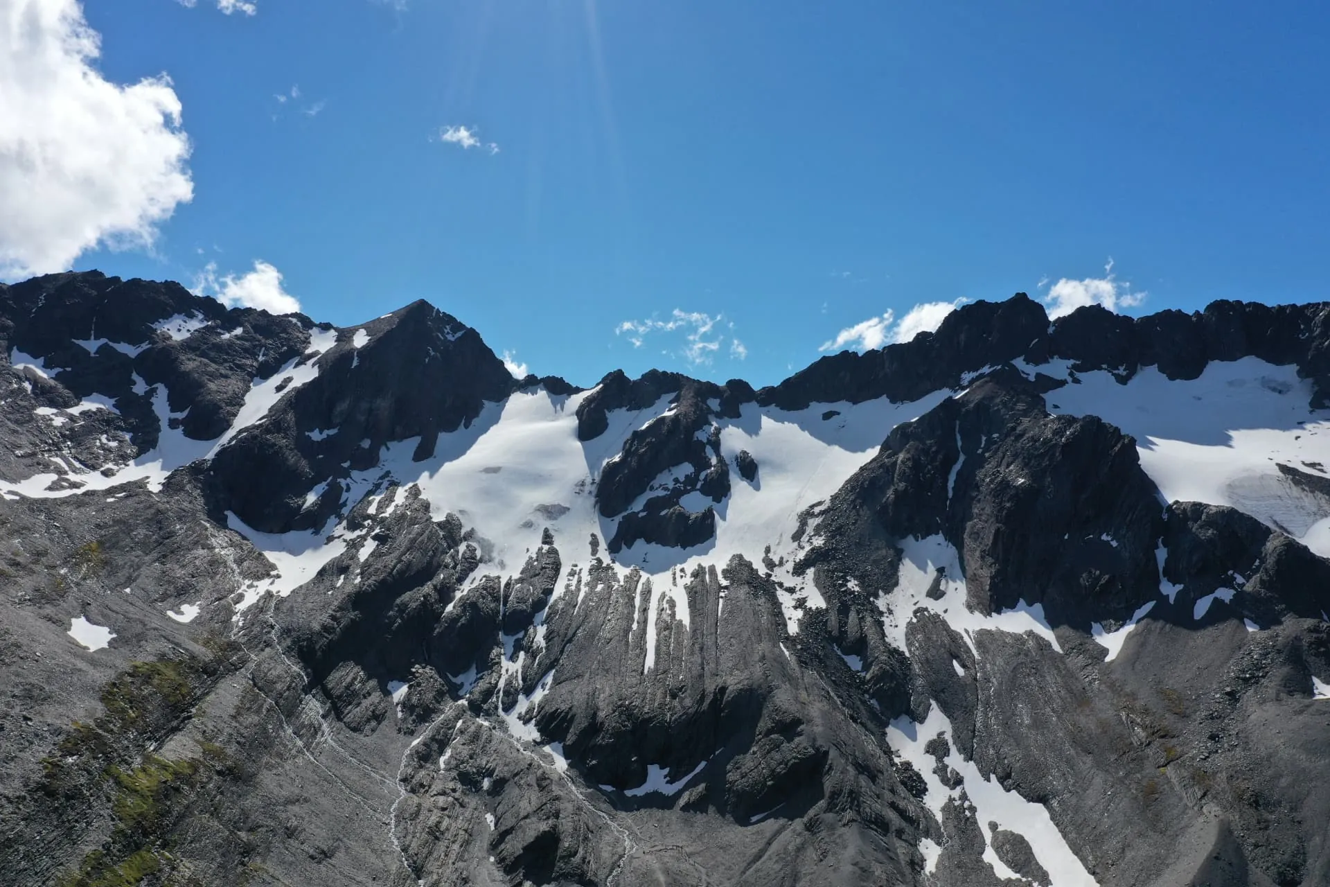 Jagged Andean ridgeline near Ushuaia with snow filling the couloirs and gullies under a clear blue sky