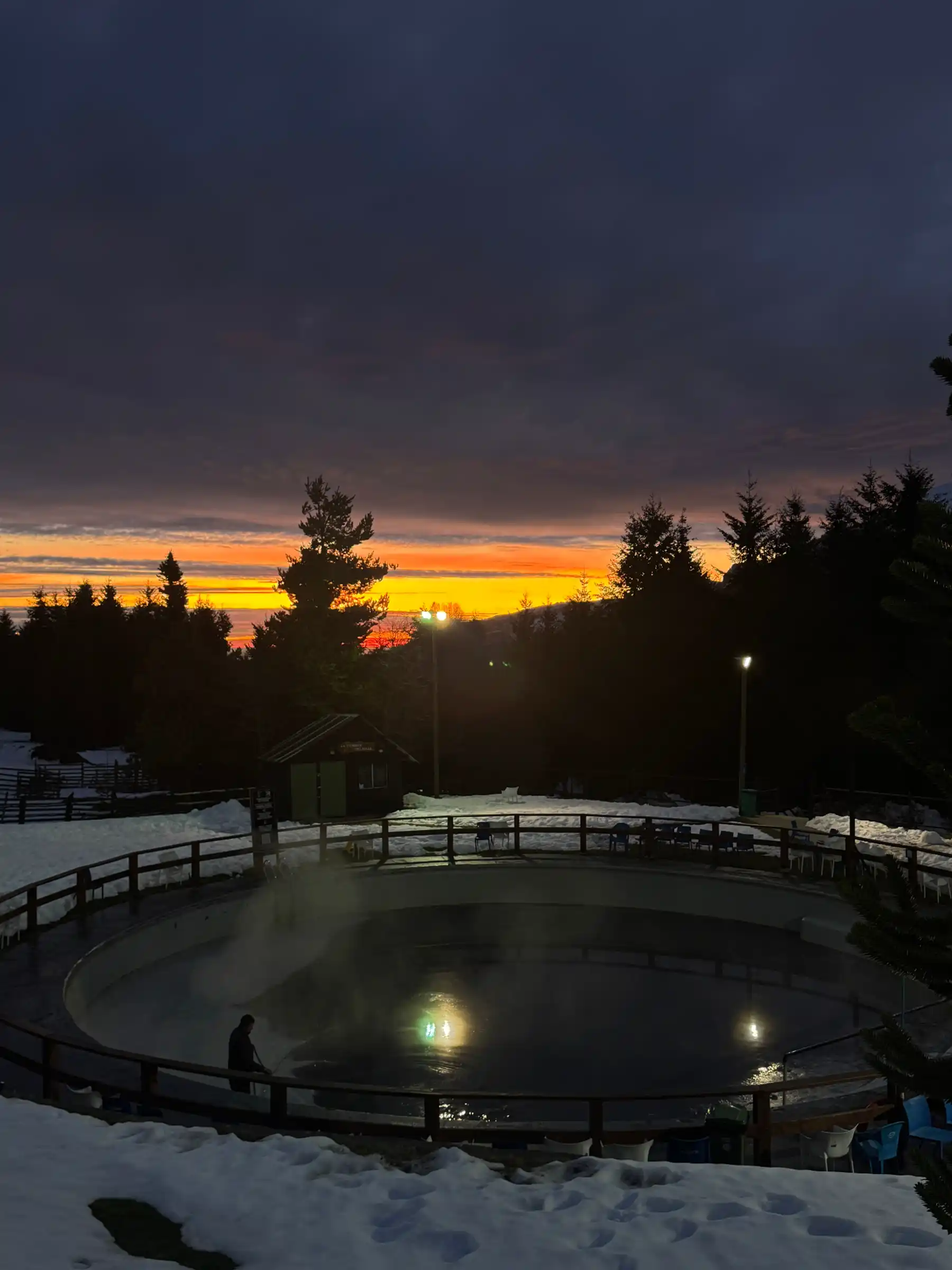 Sunset over the ice rink and araucaria trees at Nevados de Chillán resort base