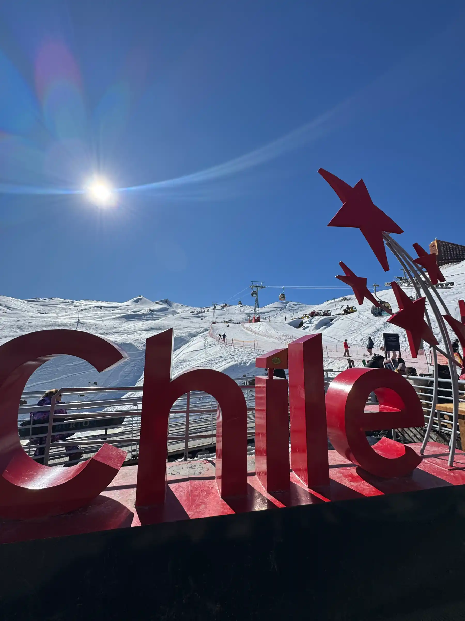 Red 'Chile' sign at Valle Nevado base with Andes Express slopes and gondola above